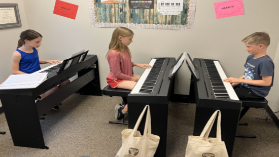 Sophie Taggart and Millie playing piano